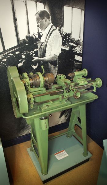 The lathe Sir John Charnley used to make cups for his hip replacements, with a photograph of him at work behind it